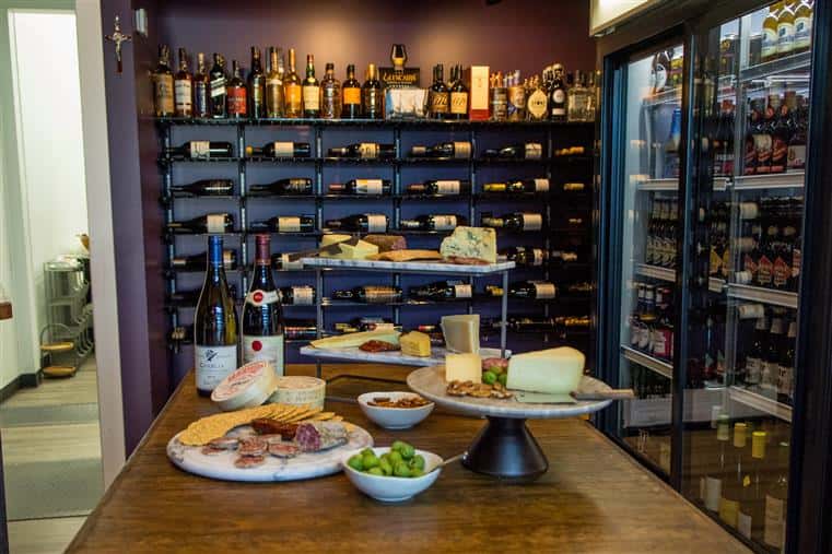 charcuterie items with wine bottles on a table