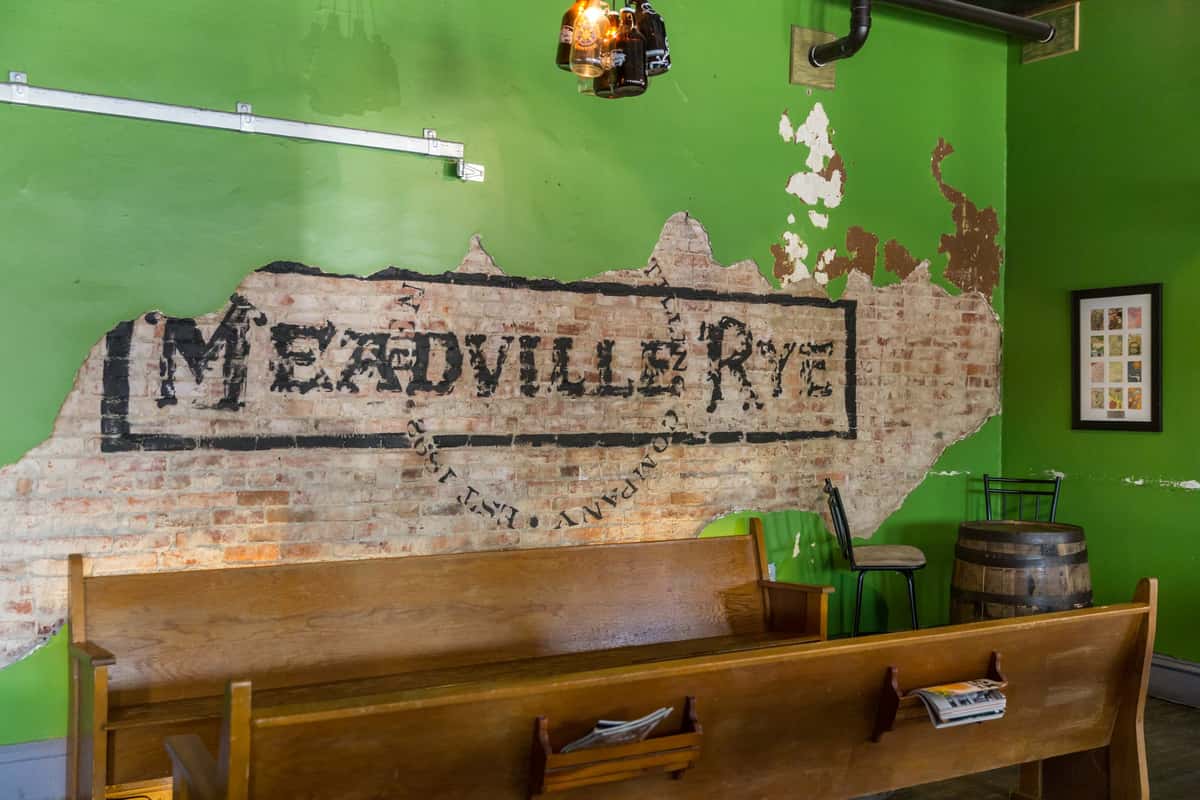 Exposed brick wall with 'Meadville Rye' written on the brick