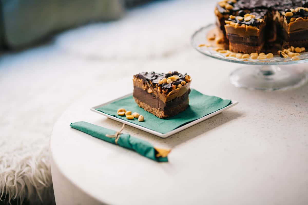 Close-up of a chocolate peanut butter dessert slice on a green napkin.