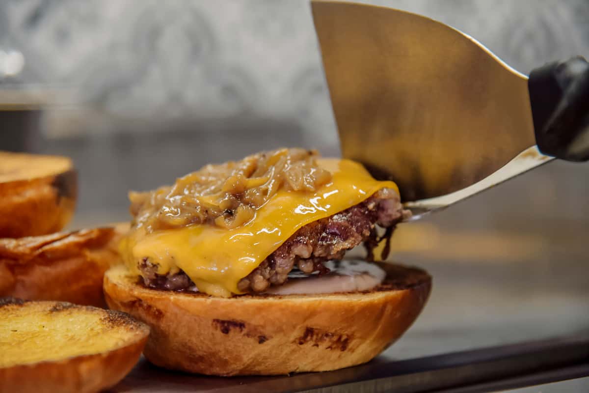 Delicious gourmet hamburger topped with melted cheddar and caramelized onions.