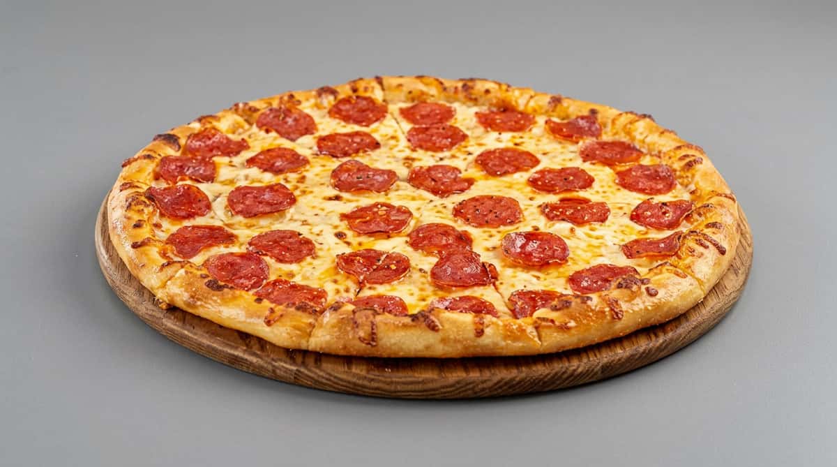 Pepperoni pizza with melted cheese on a wooden pizza peel.