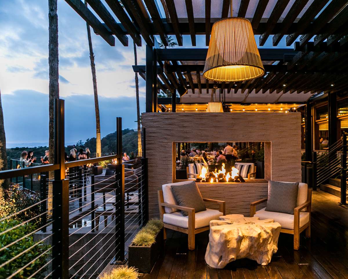 Cozy seating by a fireplace on an outdoor dining patio