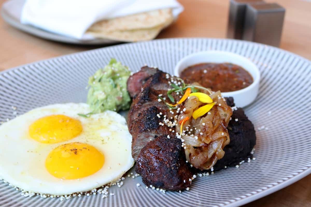 Bistec con Huevos, grilled steak with fried eggs, a hearty brunch plate at Zaranda Houston