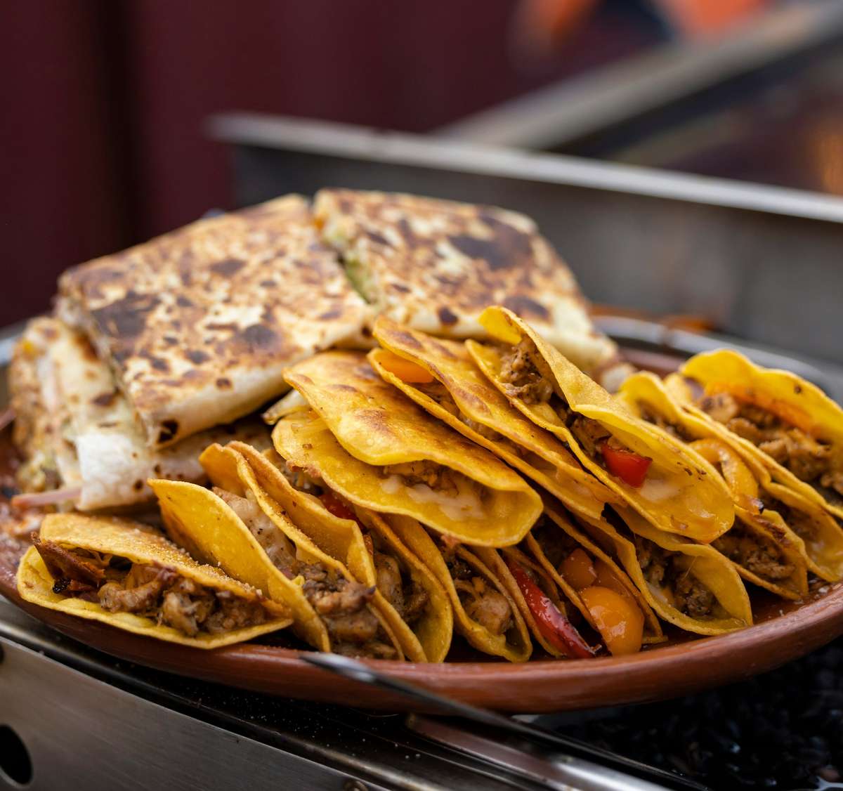 Crispy tacos and quesadillas are displayed on a plate ready to be served at The Salty Rim, a fun beach restaurant.