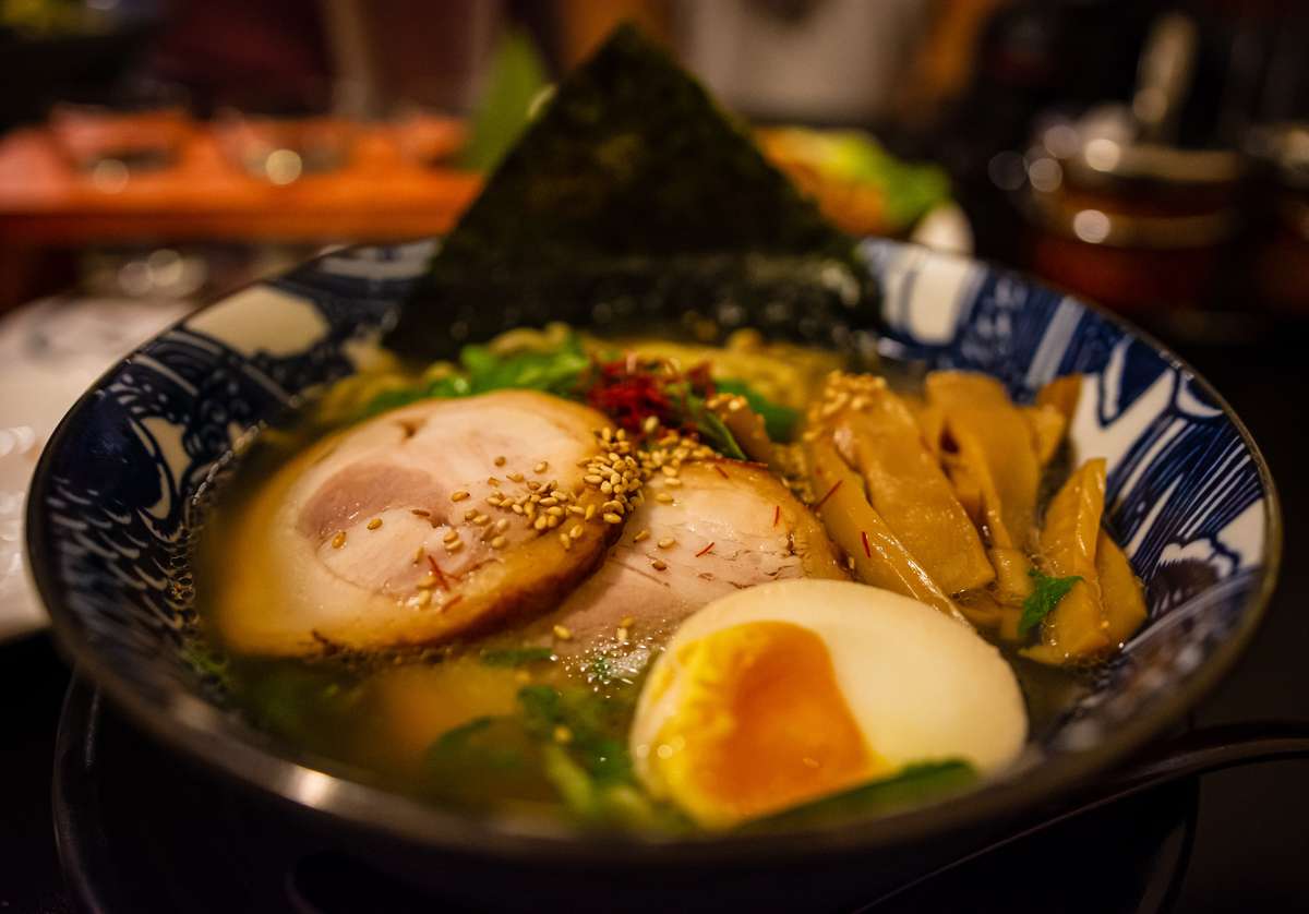 ramen with meat, egg, bamboo shoots and sesame seeds