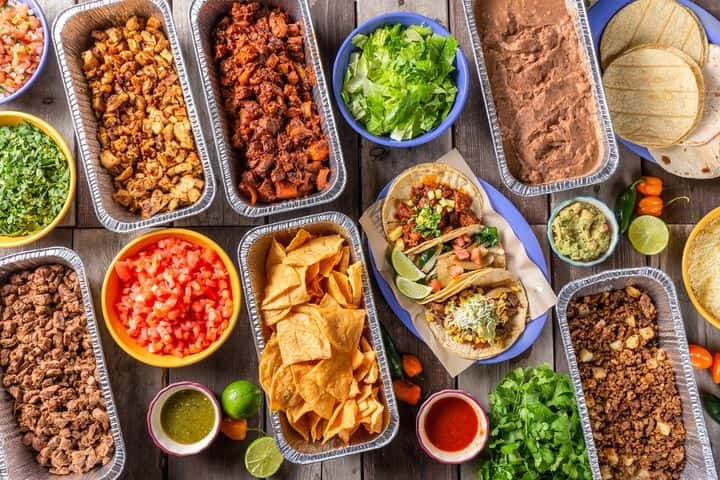 Two Step Taqueria catering spread with tacos, proteins, chips, salsa, guacamole and tortillas in Austin
