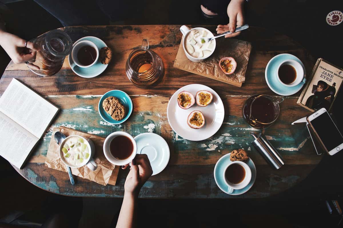 top view of table with coffee and pastries enjoyed by customers