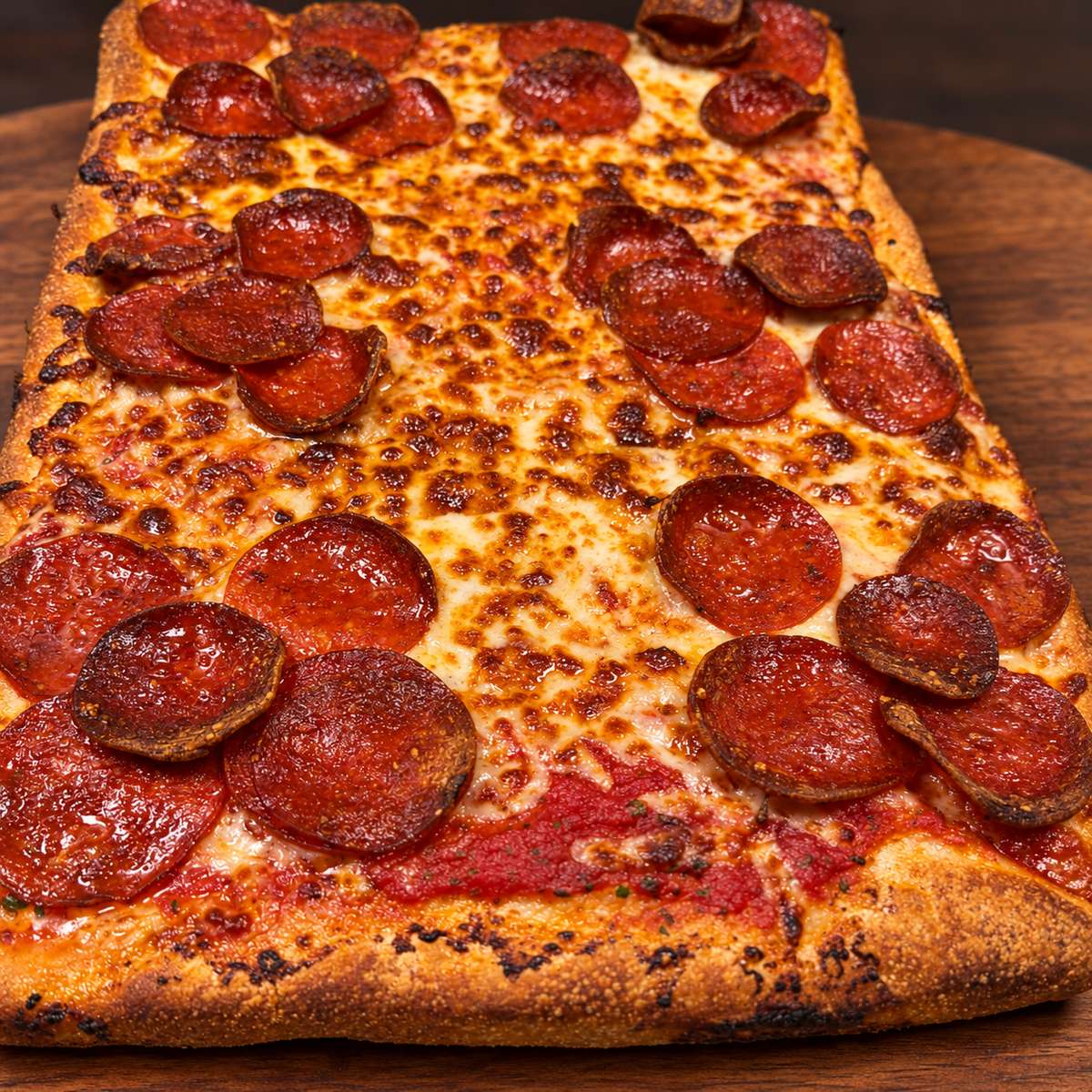Pizza slice on a warm wooden board