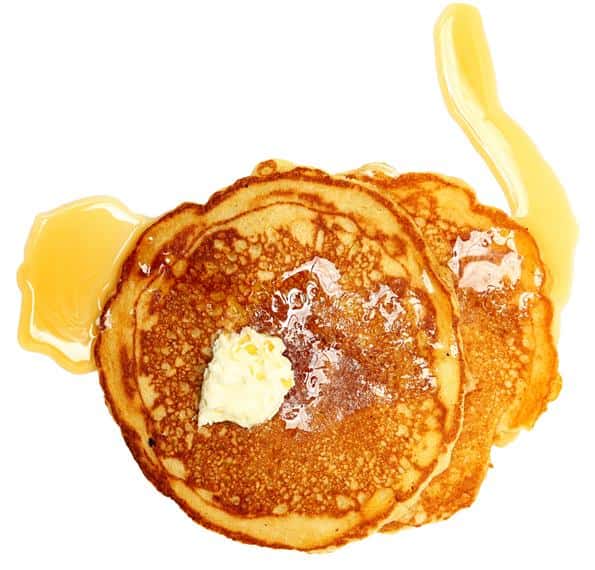 stack of pancakes topped with butter and syrup