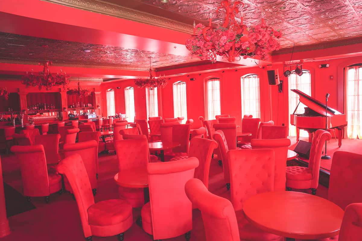 Private Events Space with a lot of tables and chairs with a red hue