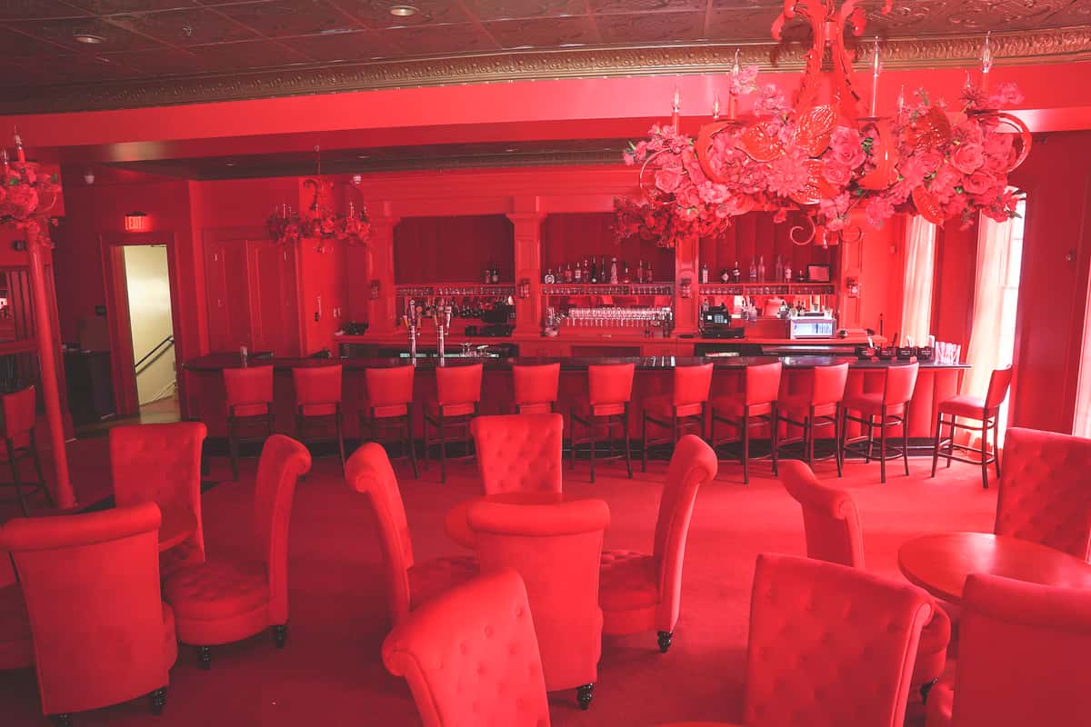Picture of the room with the tables and the bar on the back