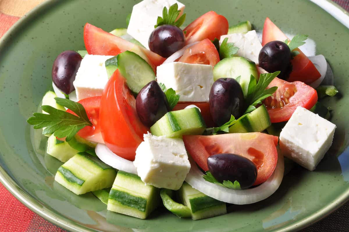 antipasto salad with mozzarella, cucumber, olives, tomatoes, and onions