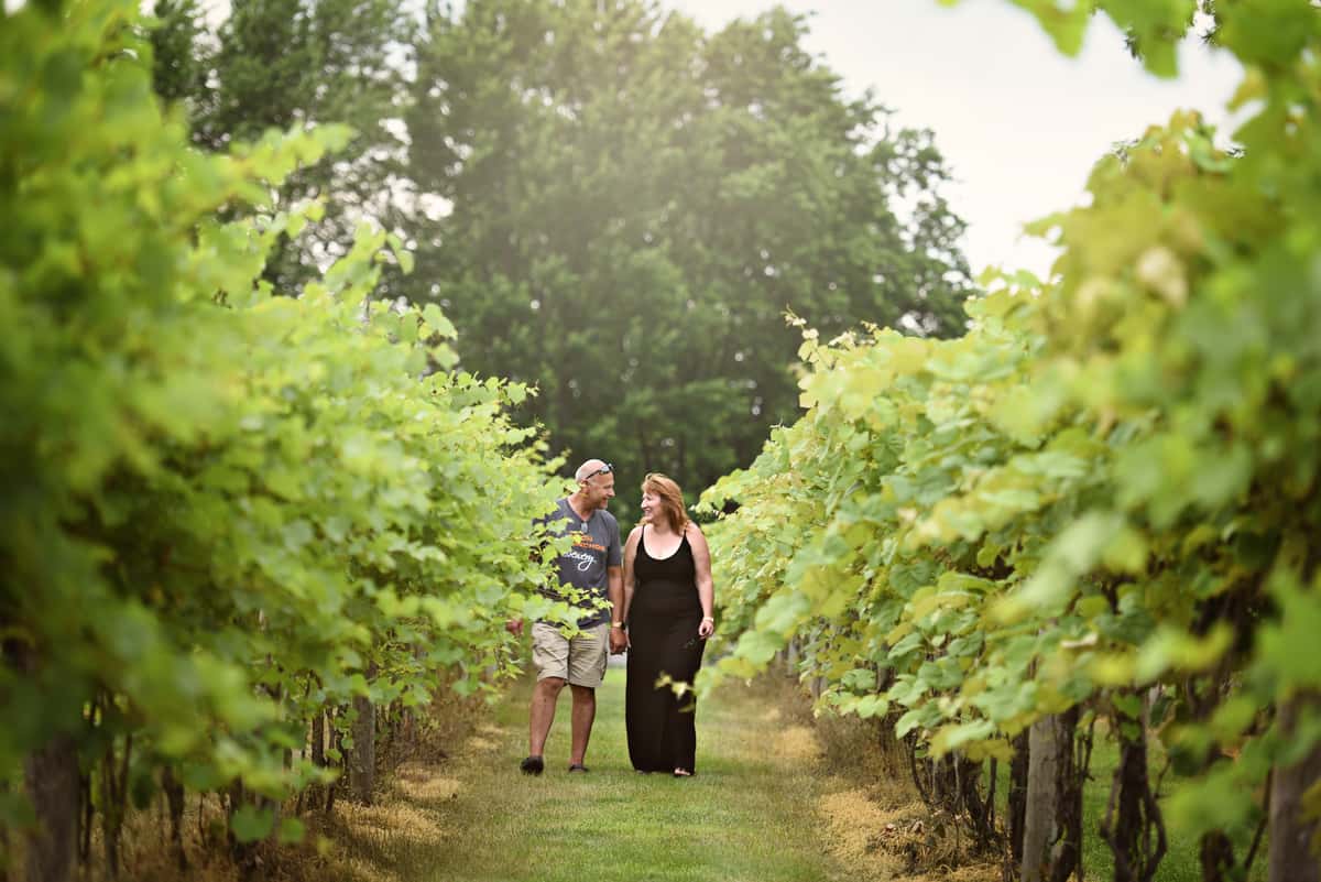 Owners of Majestic Oak Winery strolling through the grape fields