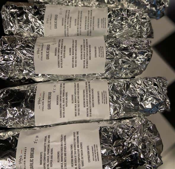 assortment of wrapped garlic bread in tin foil