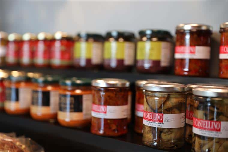 assortment of olive jars on a shelf