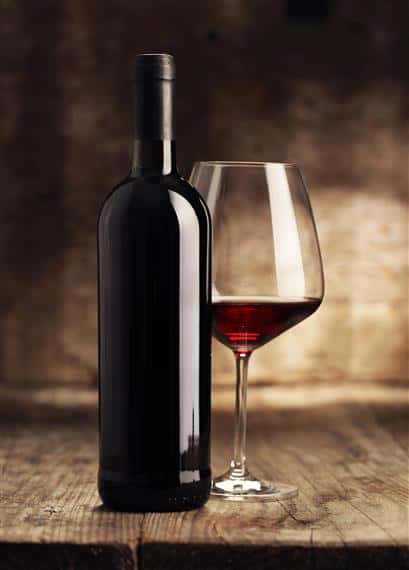 wine and bottle on a wooden table