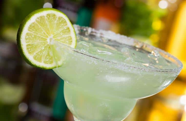 margarita in a glass with a salted rim and lime wedge
