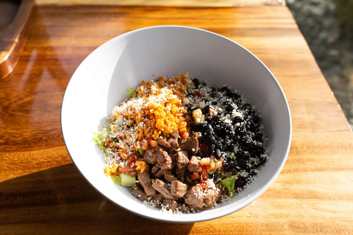Marinated flank steak, grilled and chopped served with the choice of Roasted Peruvian Potatoes or Rice (4oz), Beans (4oz), Romaine Lettuce, Pineapple Pico de Gallo and Queso Fresco.