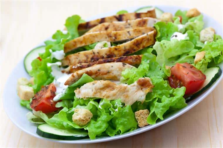 Salad with croutons, tomatoes, cucumbers, and grilled chicken
