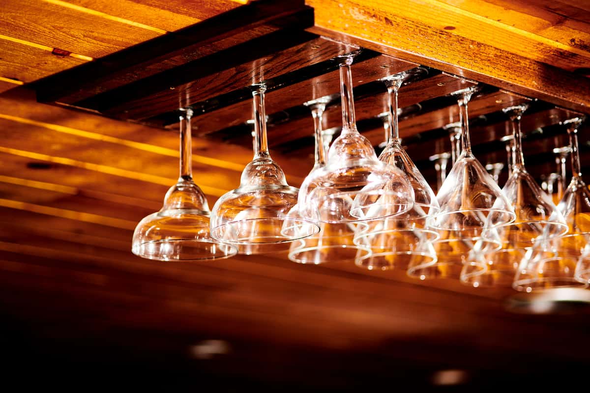 Wine glasses hanging from a ceiling