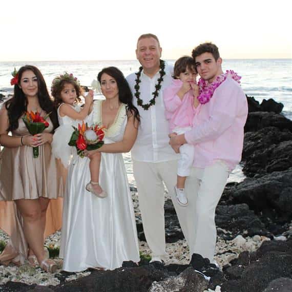 family in formal clothes at the beach