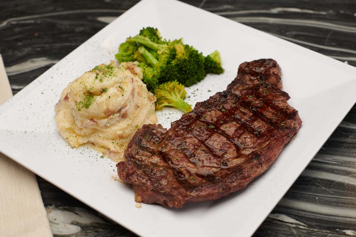 Ribeye steak with mashed potatoes and broccoli