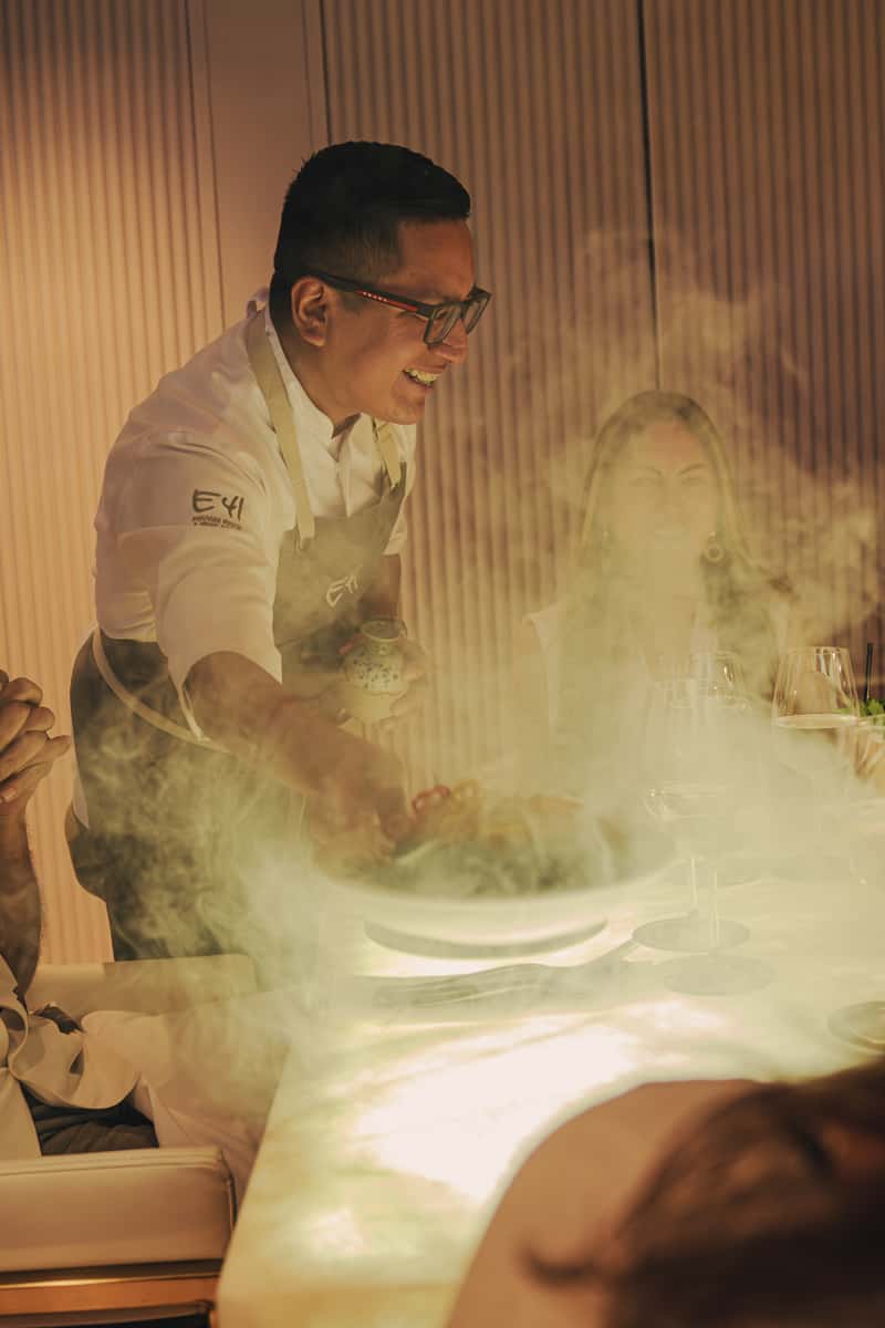 Employee happily serving a dish to customers