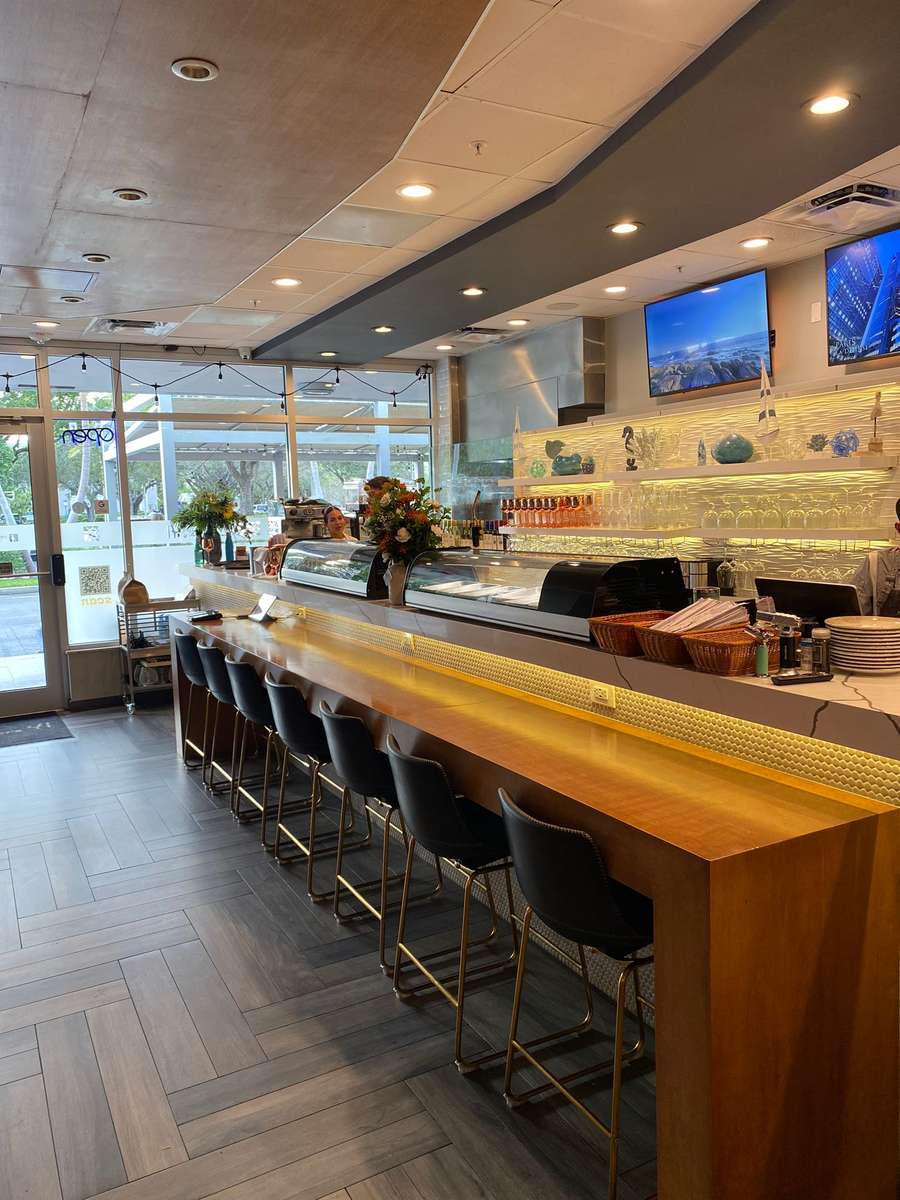 Interior dining area near kitchen with outdoor view and warm interior lighting