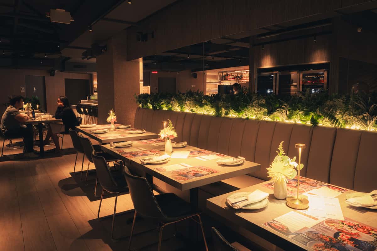 Restaurant dine in space with soft warm lighting and laid tables