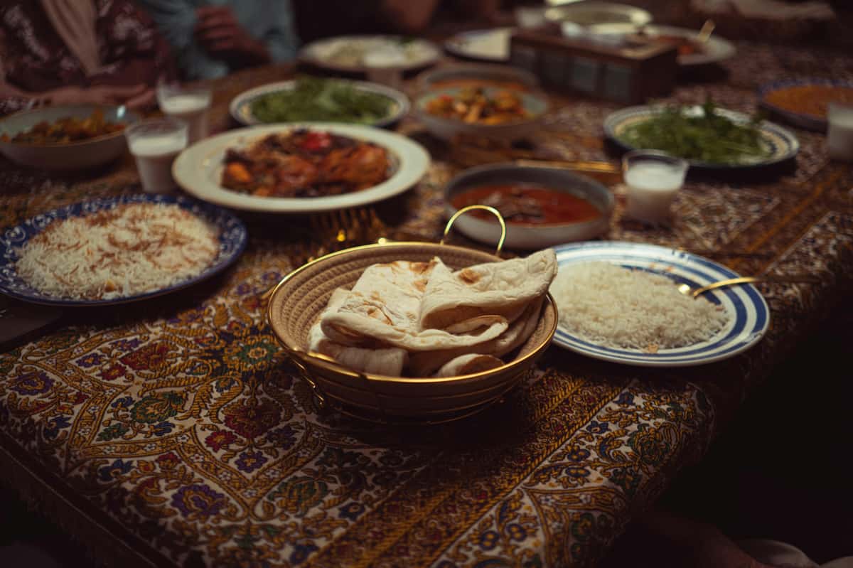 A vibrant spread of Indian dishes on a colorful tablecloth, perfect for culinary themes.