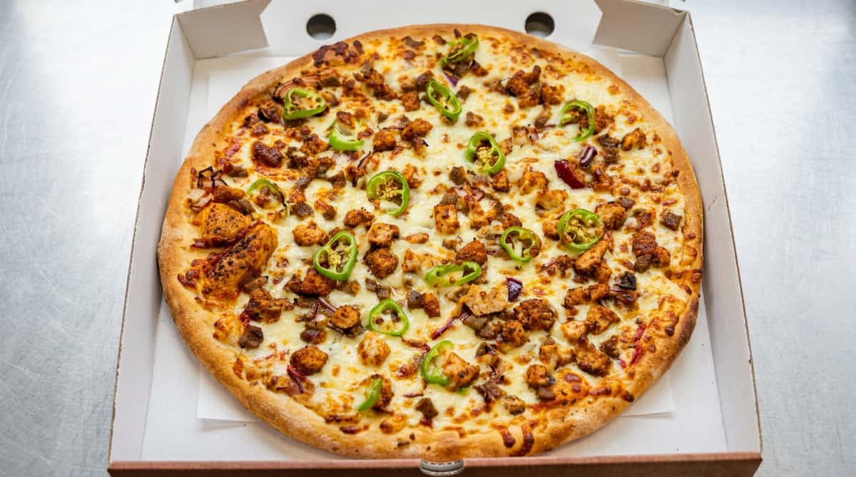 Chicken cheesesteak pizza at Sivas Tavern topped with seasoned chicken, cheese, and savory herbs