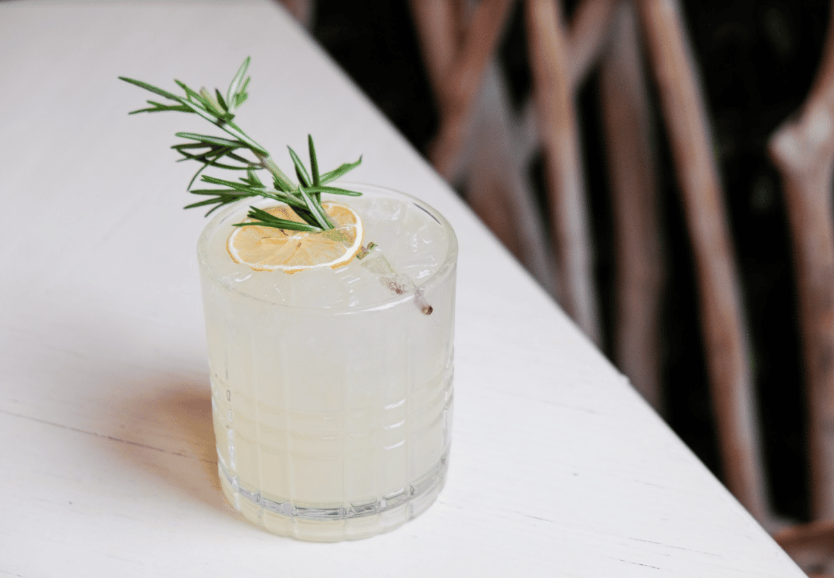 cocktail with rosemary lemon garnish