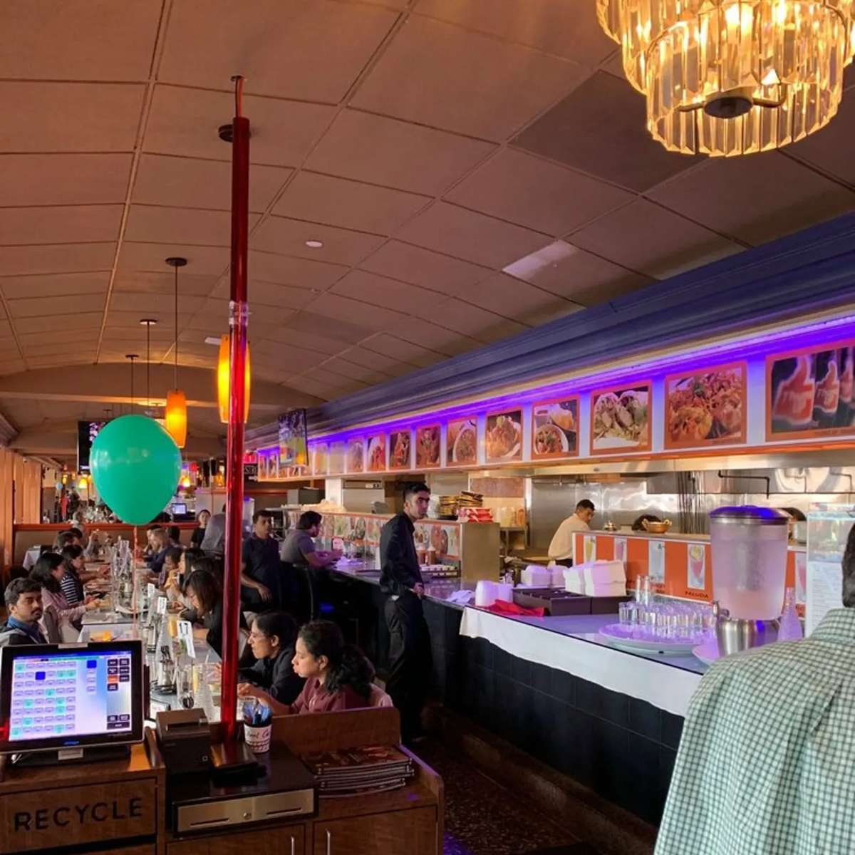 Happenings at the Chaat Corner restaurant with people celebrating