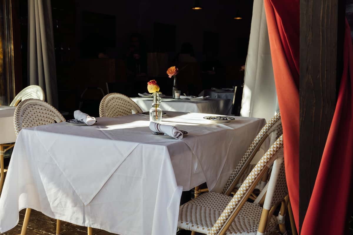 Dining table with a white tablecloth and flower vase