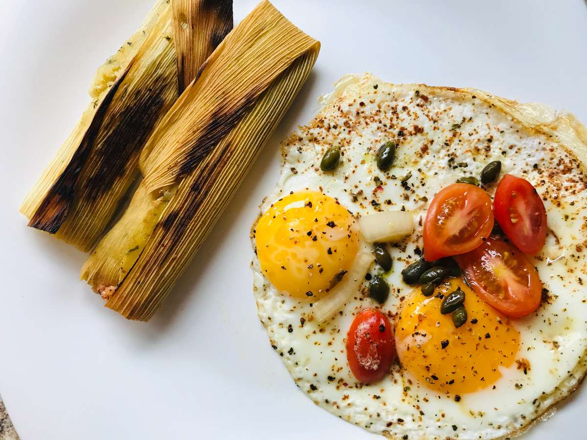 Tamales and eggs with tomatoes and beans