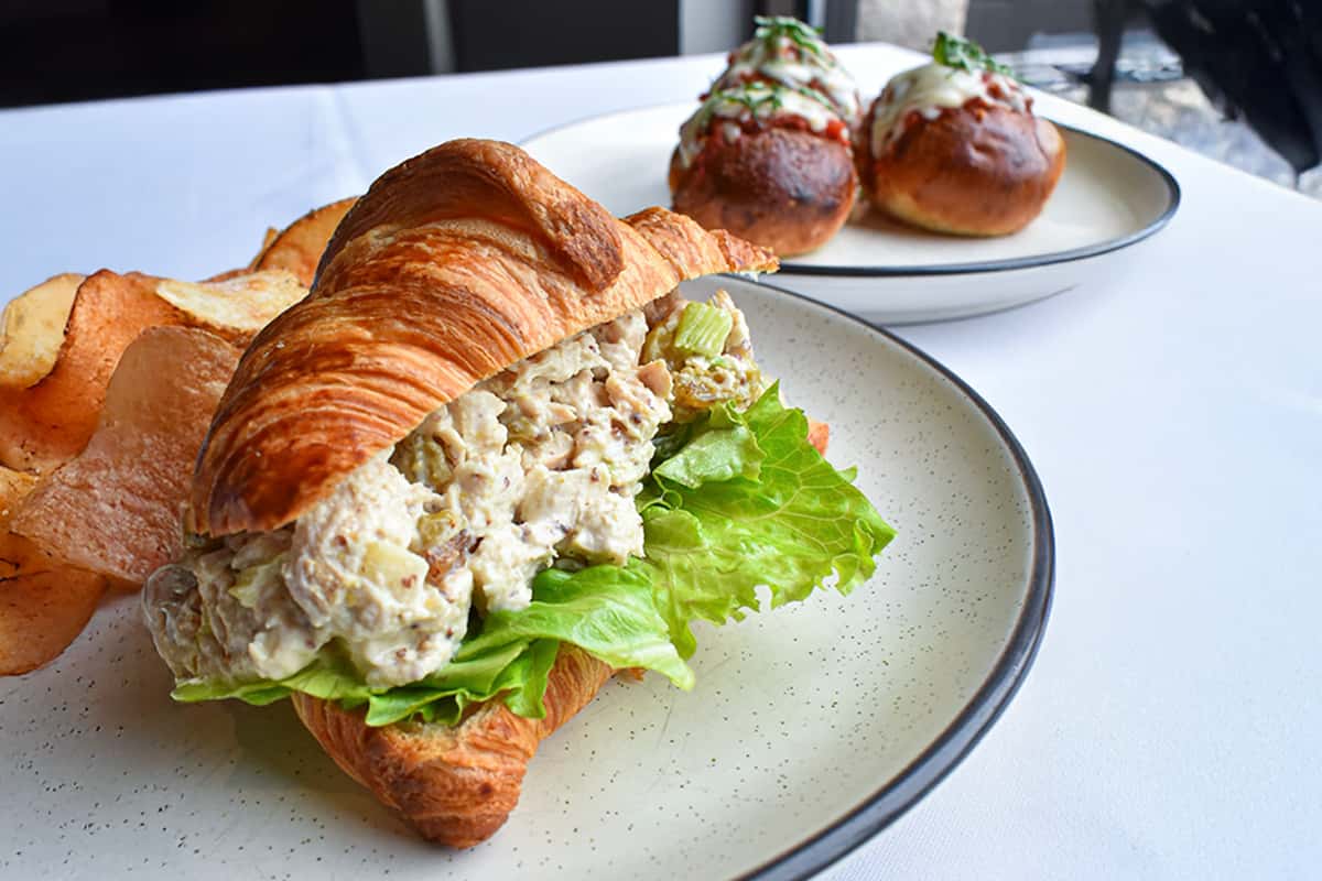 House-made chicken salad with fresh herbs, served on toasted ciabatta with crisp greens and tomato—Osteria's coastal take on a lunch classic.