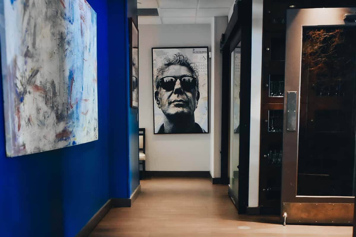 A signature hallway at Osteria featuring bold artwork and an iconic portrait of Anthony Bourdain. A glimpse of the venue's artistic, urban character.
