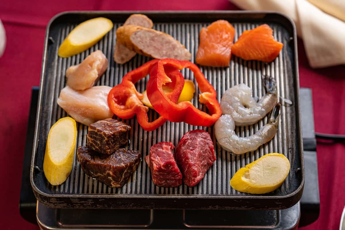 Meats and veggies on a grill
