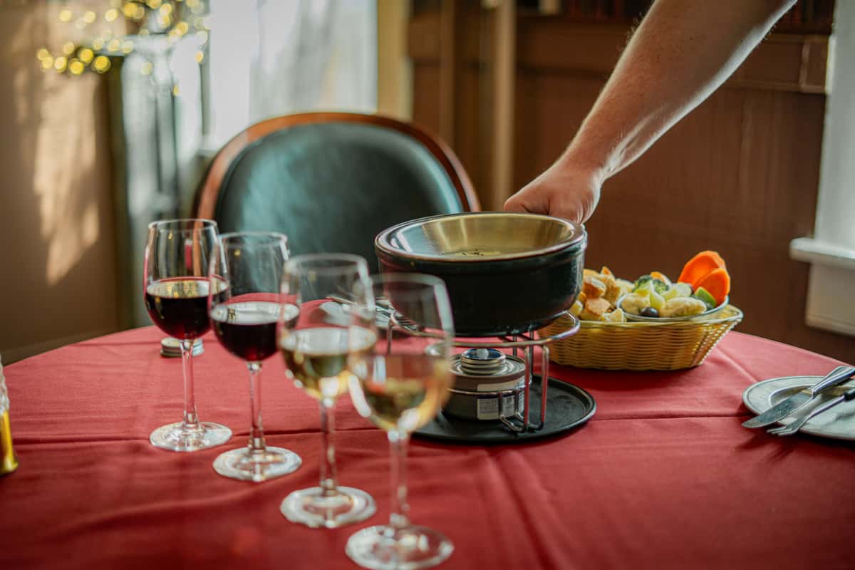 Fondue pot being placed on a dining table