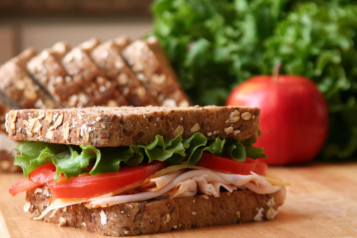 Turkey sandwich on whole wheat bread with lettuce and tomato