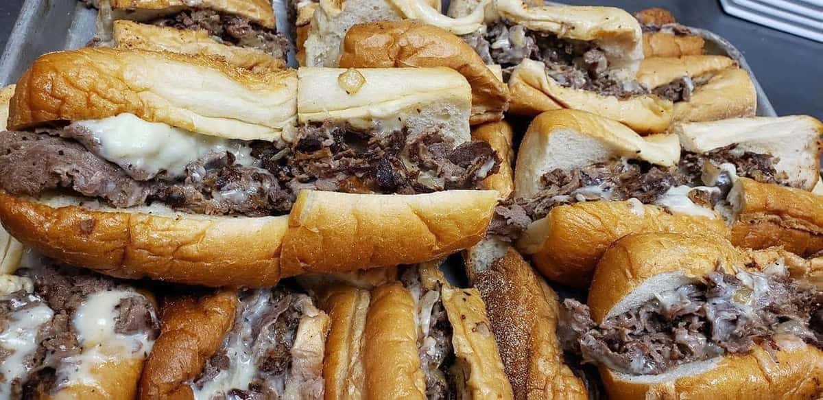 A table of Cheesesteaks stacked high