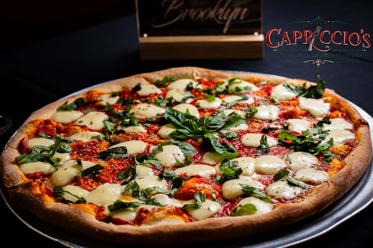 Our Margherita Pizza is a classic favorite made with fresh mozzarella, rich tomato sauce, and fragrant basil on our New York-style crust. Simple, fresh, and full of authentic Italian flavor in every bite.