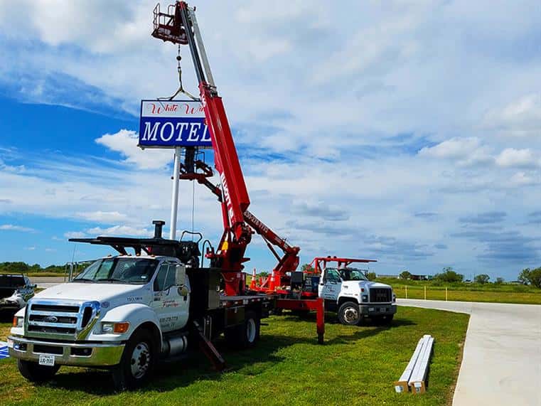 Machine instaling a new sign for a local Motel