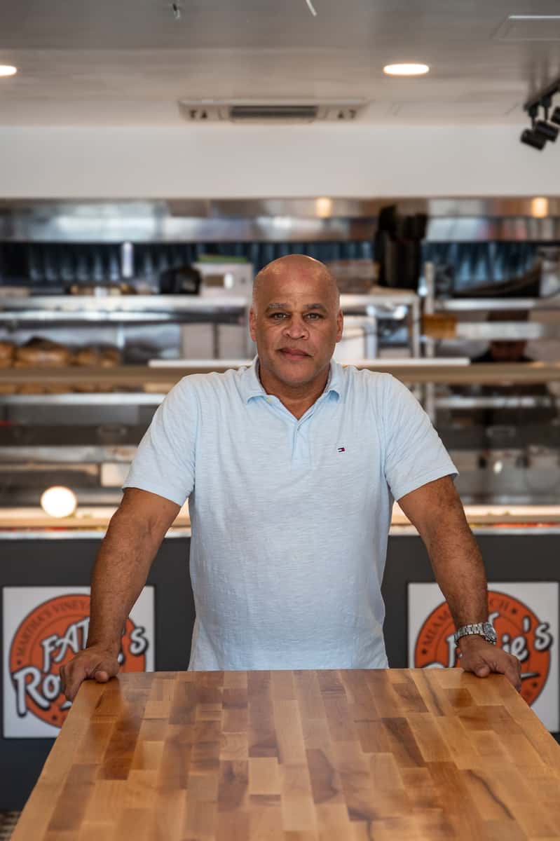Owner, Ronnie, posing in front of the kitchen