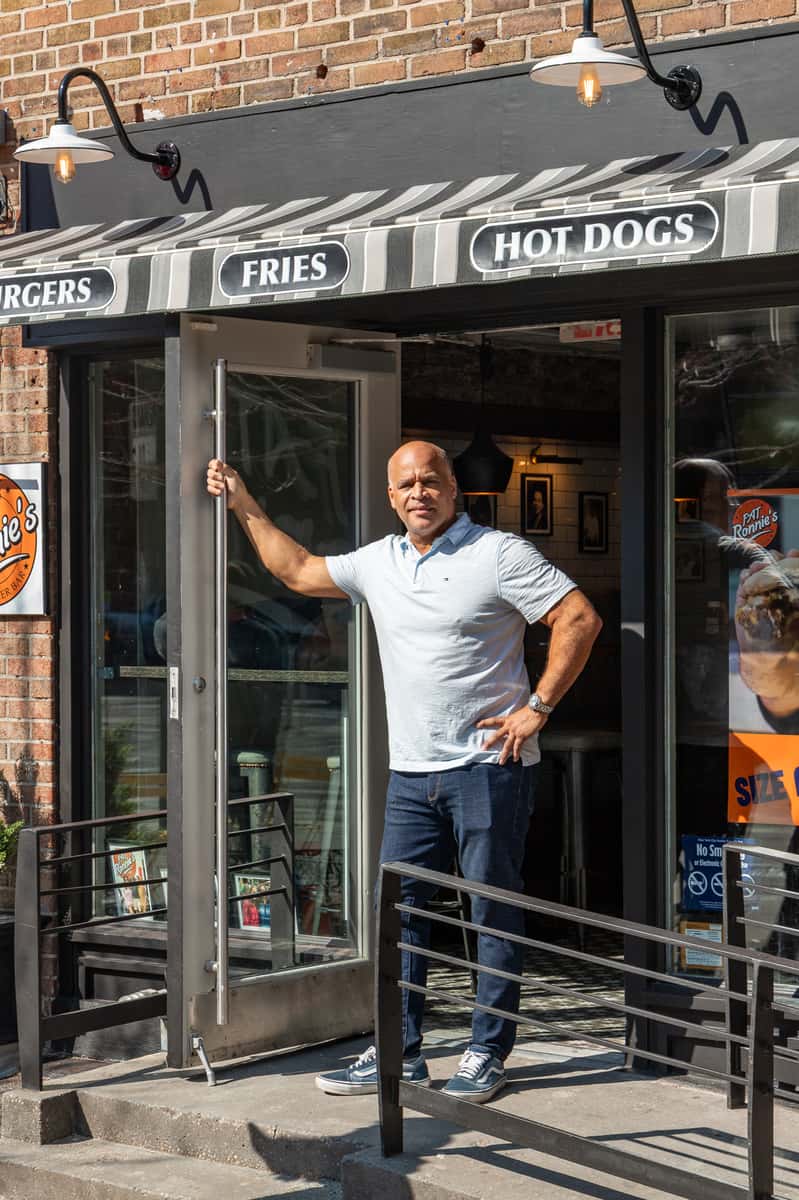 Ronnie Faust standing in front of his New York City location