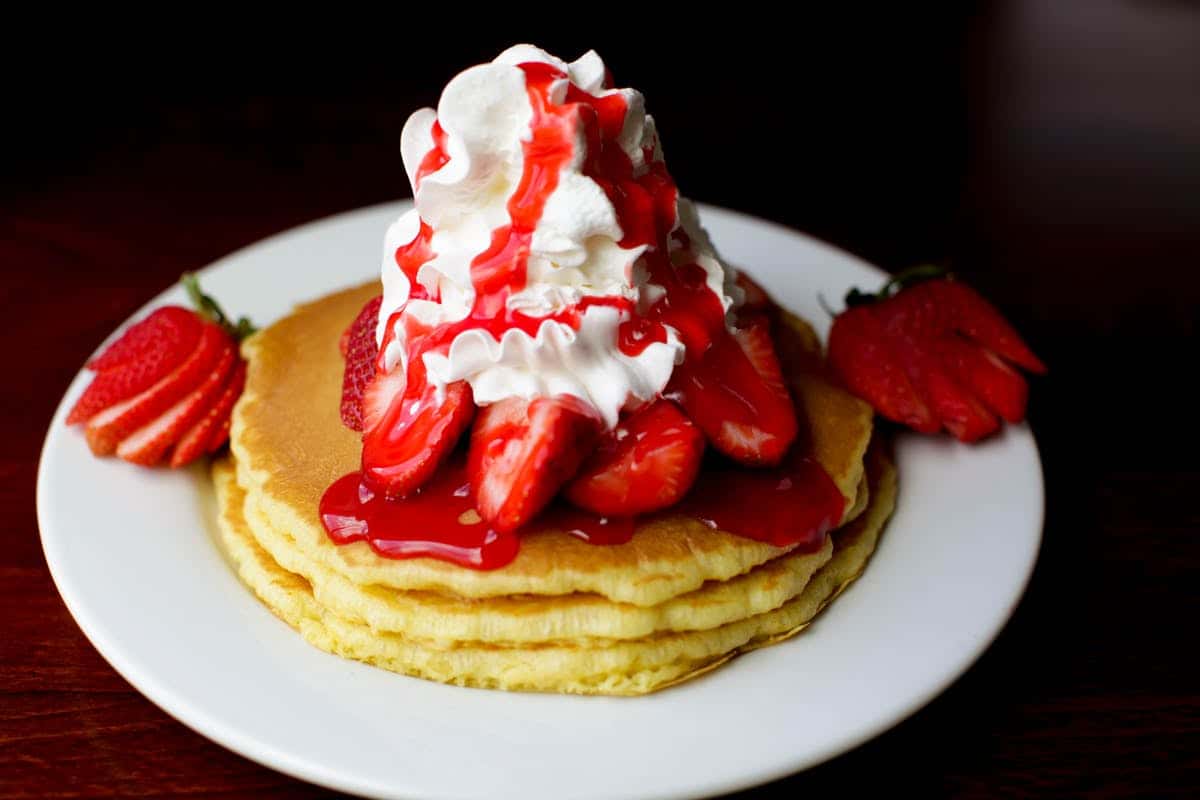 Pancakes with whipped cream and strawberries