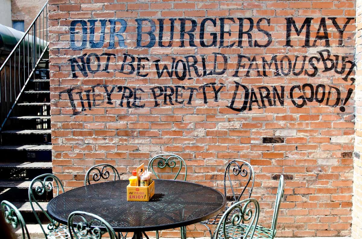 table in front of wall mural with quote