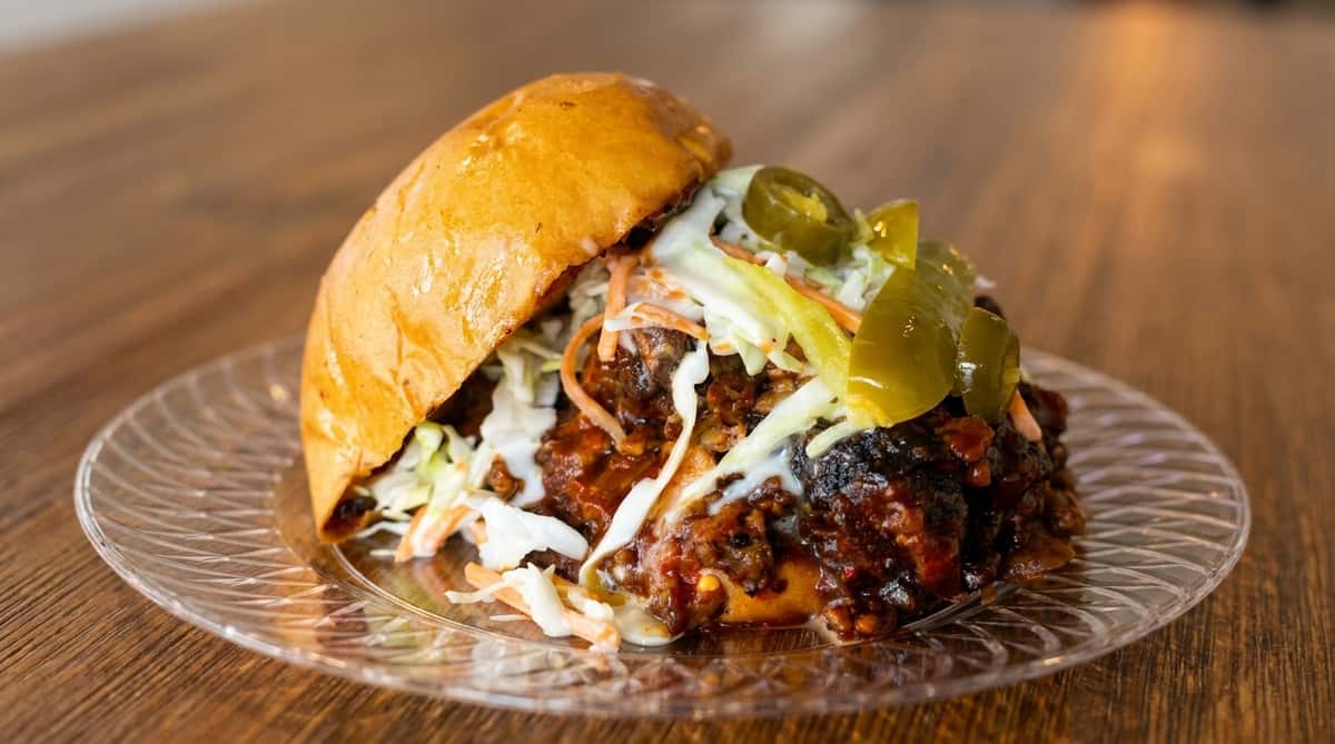 Tennessee-style pulled pork sandwich with slaw and pickles at Fainmous BBQ in Pearland TX
