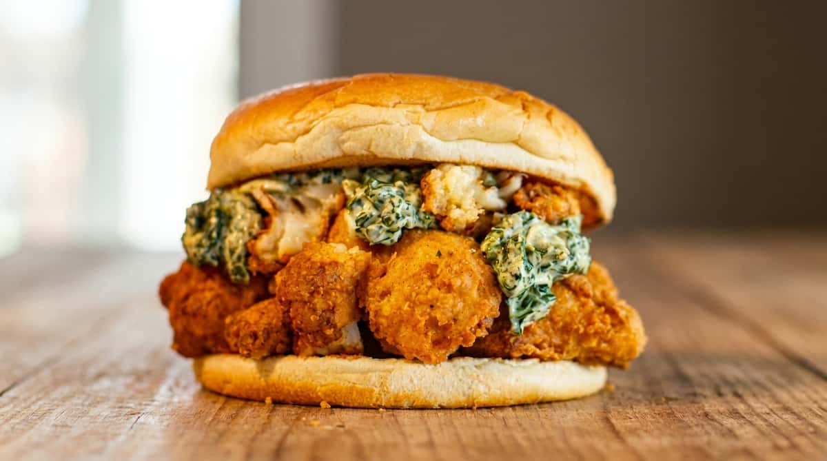 Crispy fried chicken sandwich with creamy sauce at Fainmous BBQ Pearland TX