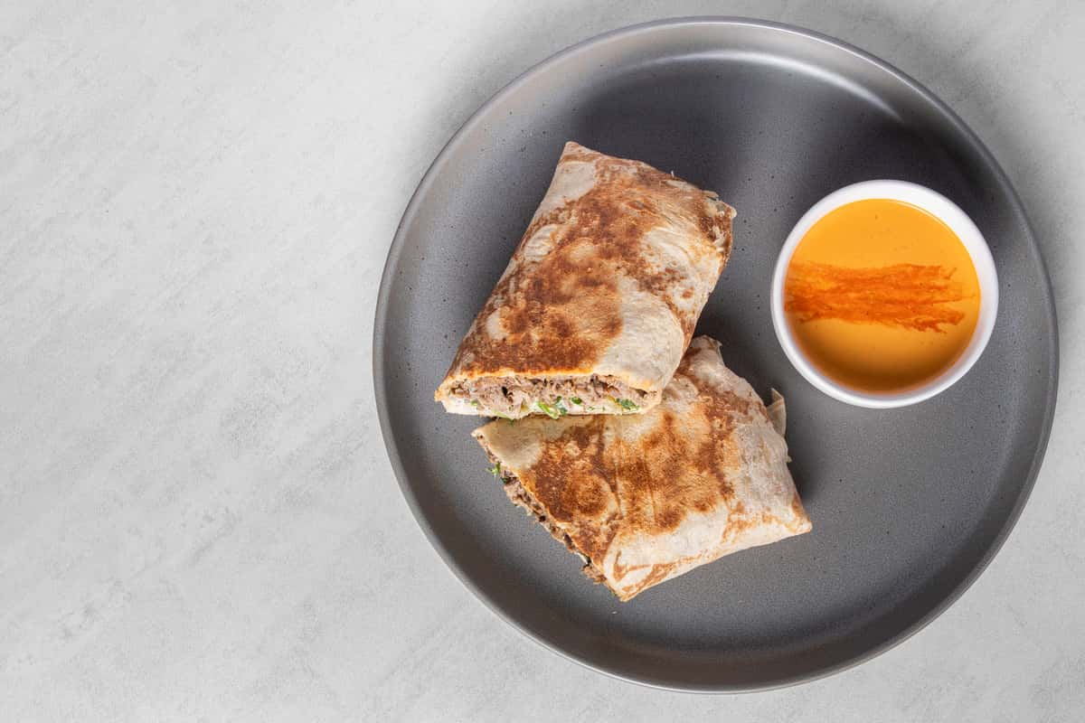 Top down view of Classic Angus Beef Shawarma on a gray plate